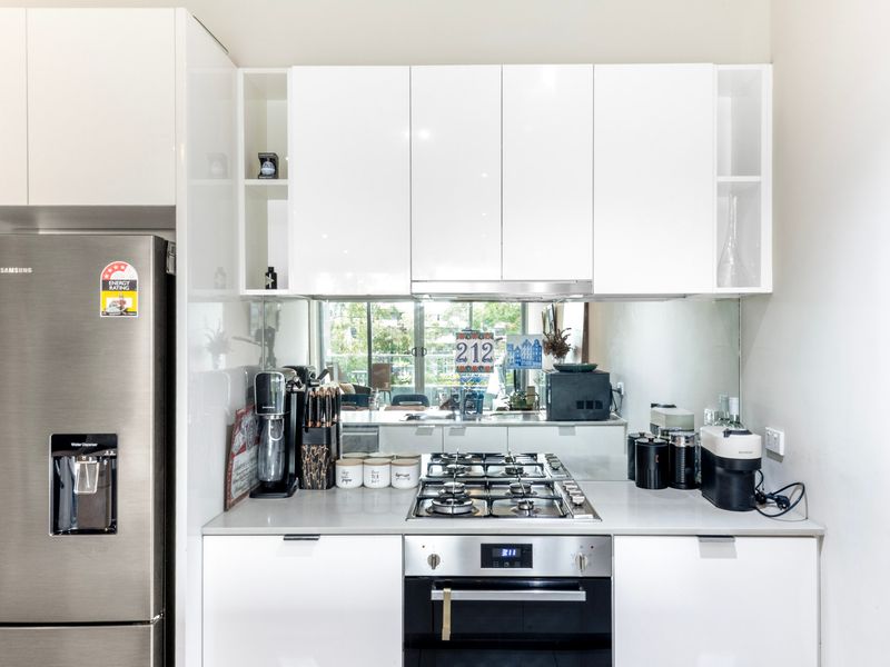 Modern kitchen with stainless steel appliances and everything you need to cook at home.
