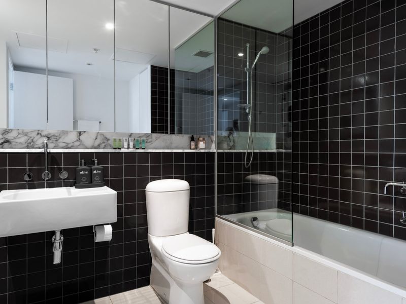 Dual vanity bathroom with bathtub and premium fittings