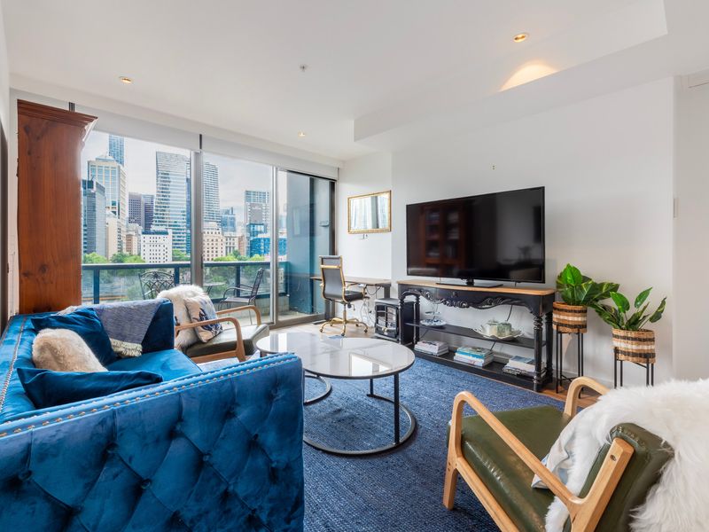 Comfortable living area featuring soft seating and a large smart TV