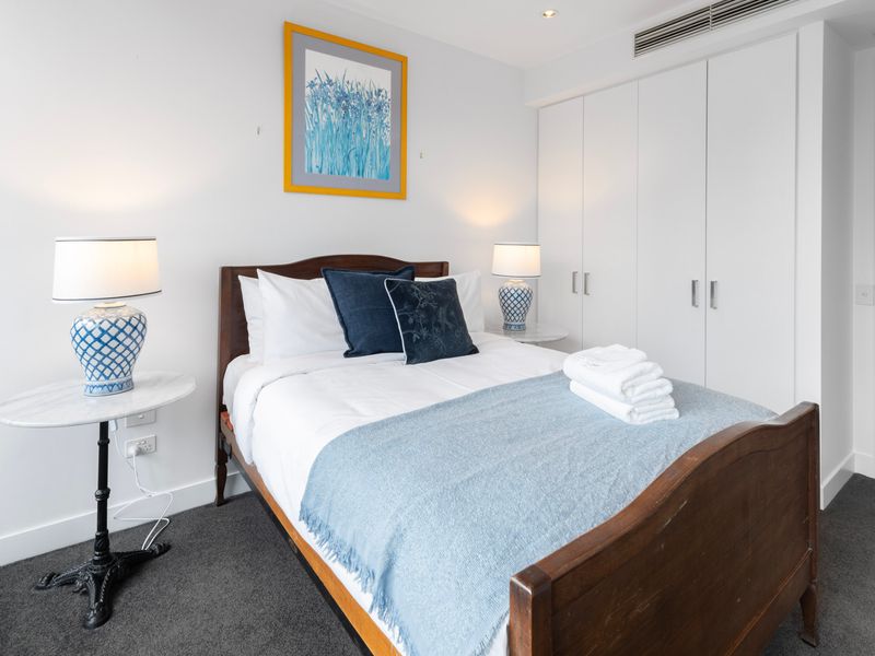 Stylish bedroom with artwork and ample wardrobe space