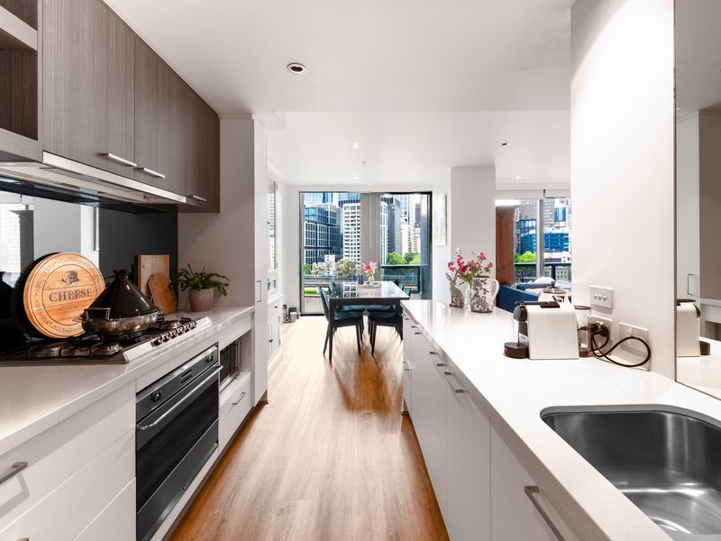 Kitchen with stainless steel appliances and city outlook