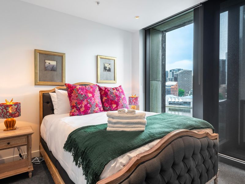 Cozy bedroom with plush bedding and plenty of natural light