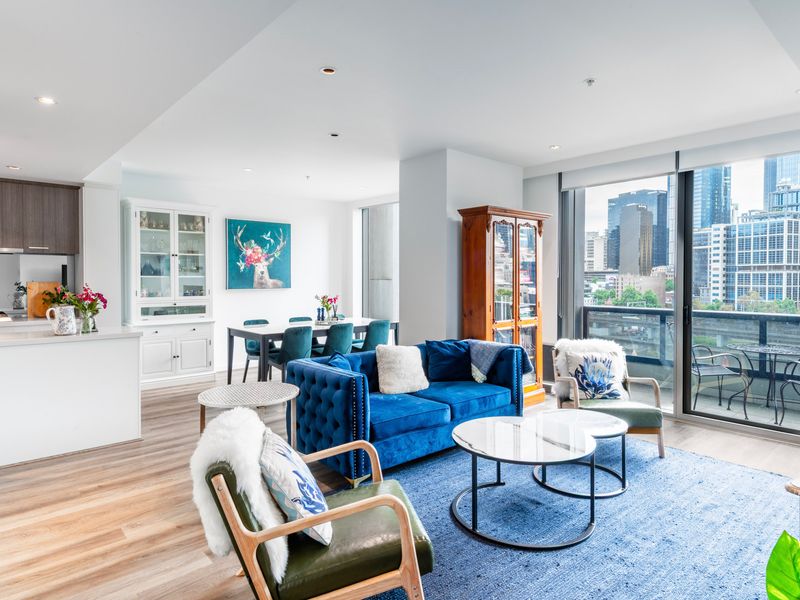 Bright open-plan living area with floor-to-ceiling windows and balcony access