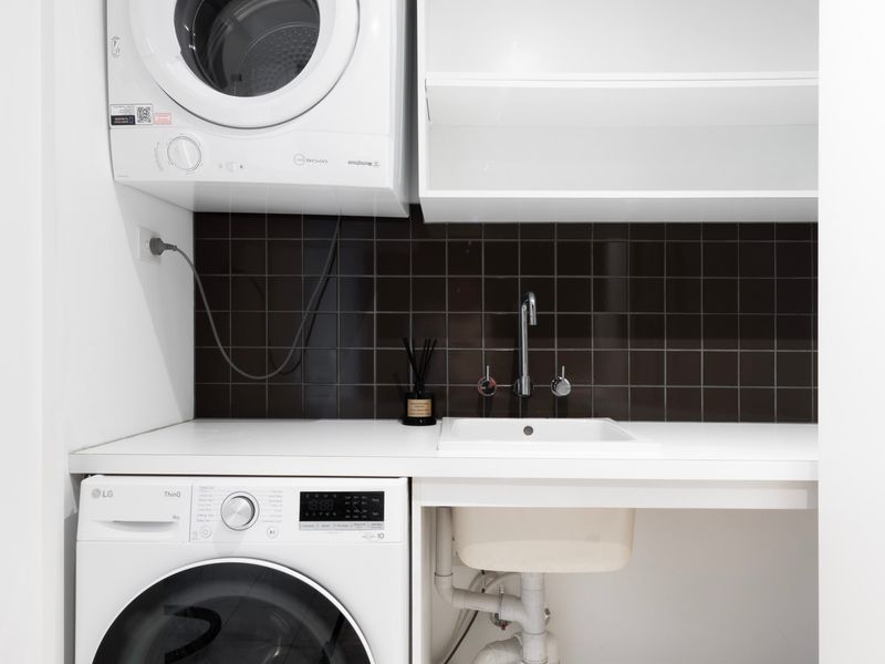 Laundry area with washer, dryer, and utility sink