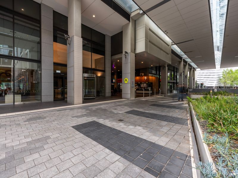 Street-level view of the building’s exterior with convenient access to shops and cafes