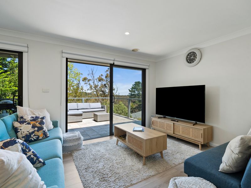Light-filled living room opening out to the balcony