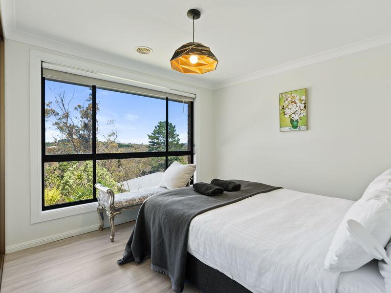 Bright bedroom with queen bed and serene outlook