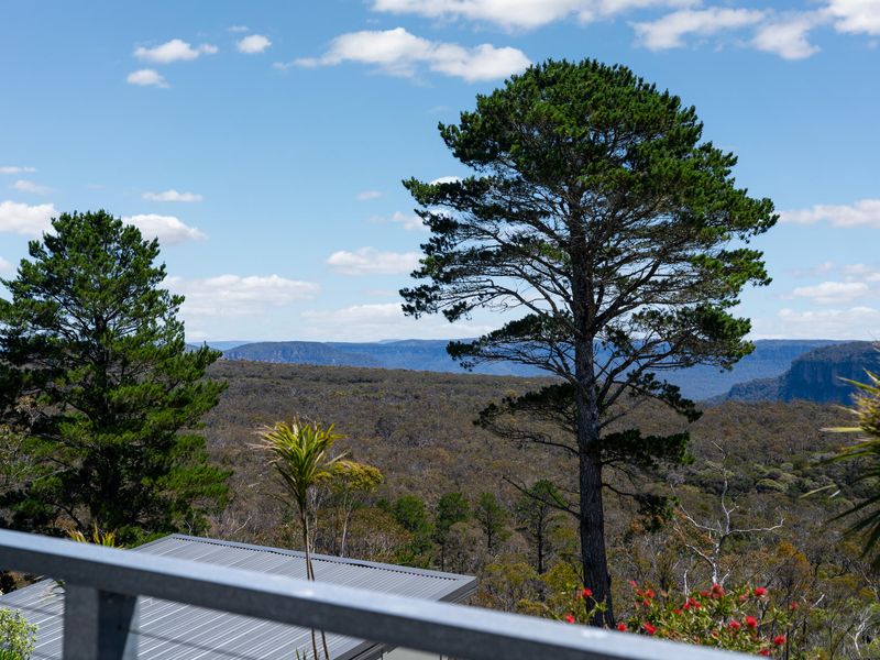 Relaxing outdoor corner lounge with treetop outlook