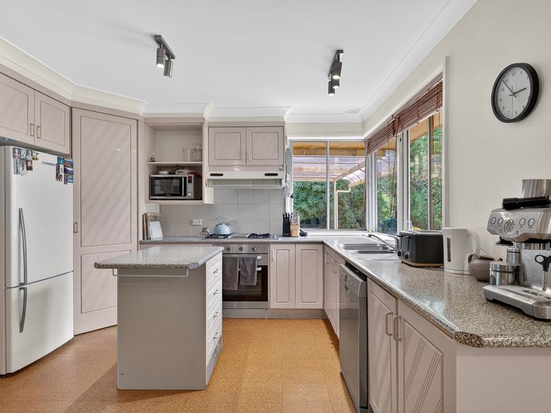 Fresh, light-filled kitchen with ample counter space and modern appliances.