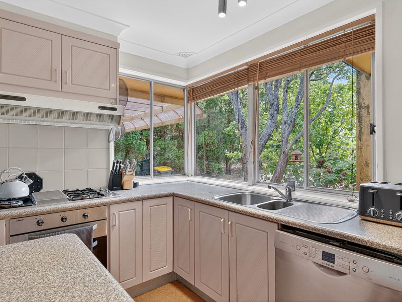 Functional kitchen with great natural light and garden outlook.