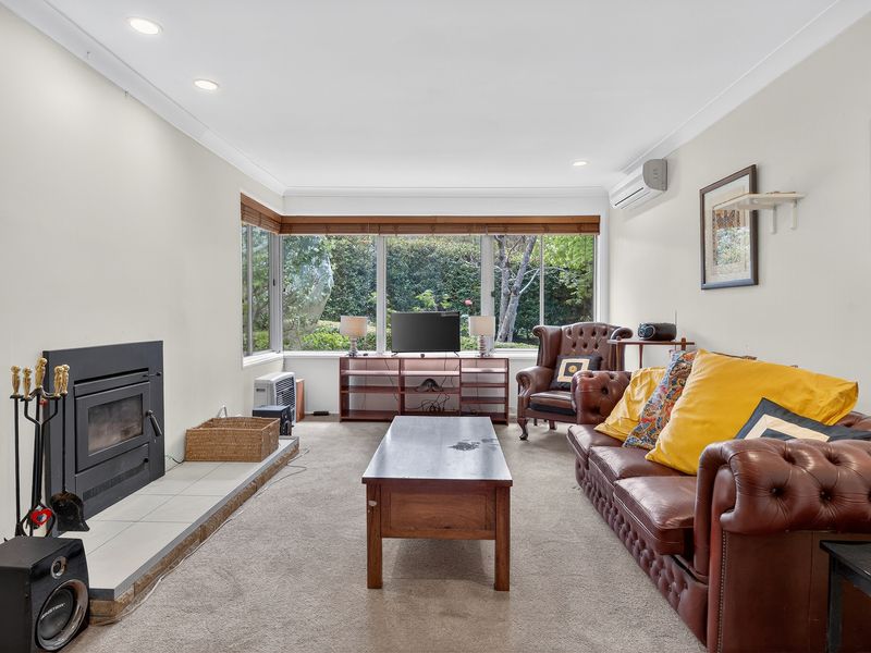 Sunny open-plan lounge with leafy views and plenty of space to unwind.