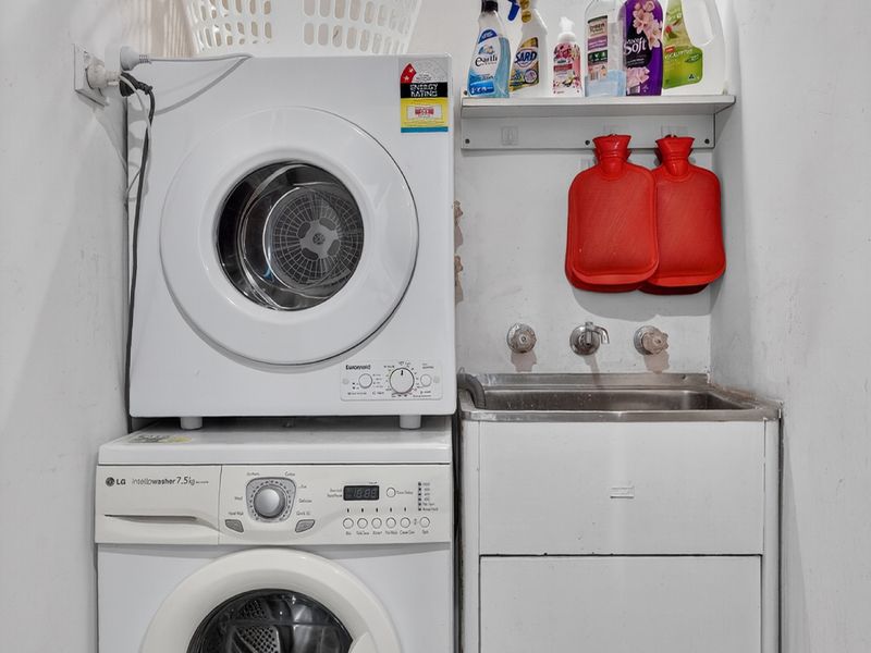 Laundry area with washer, dryer, and deep utility sink.
