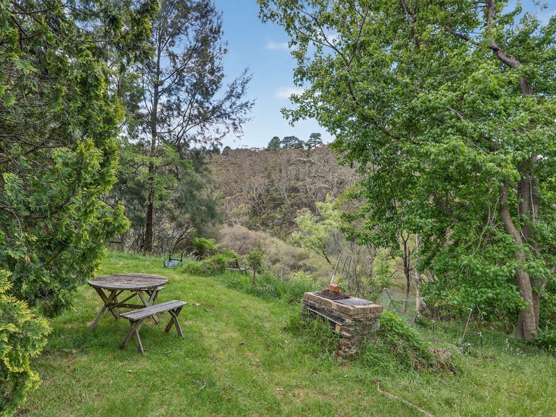 Outdoor seating spot overlooking peaceful bushland.