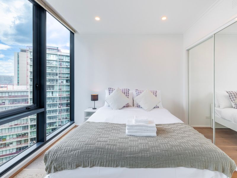 Bright bedroom with fresh linens and a comfortable bed