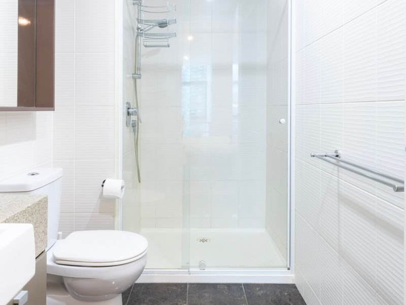 Clean bathroom featuring a walk-in shower