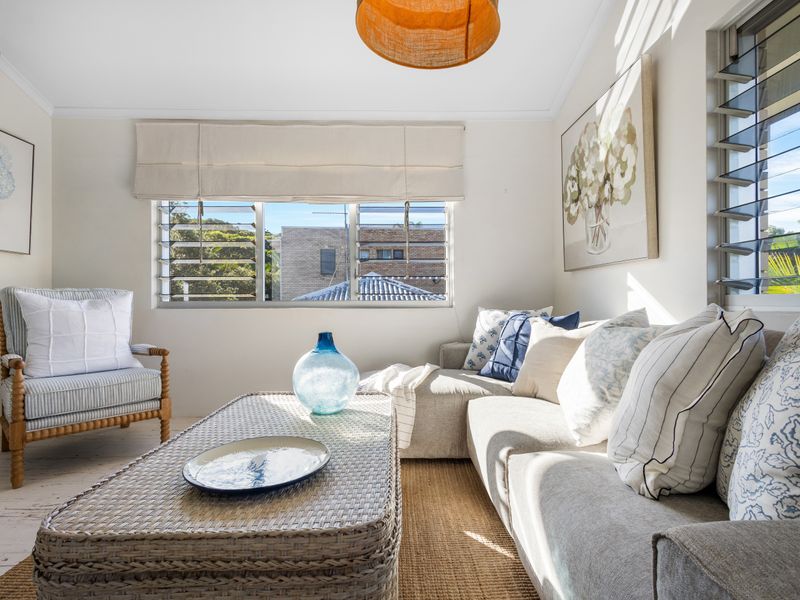 Sunlit living room with soft, neutral tones.