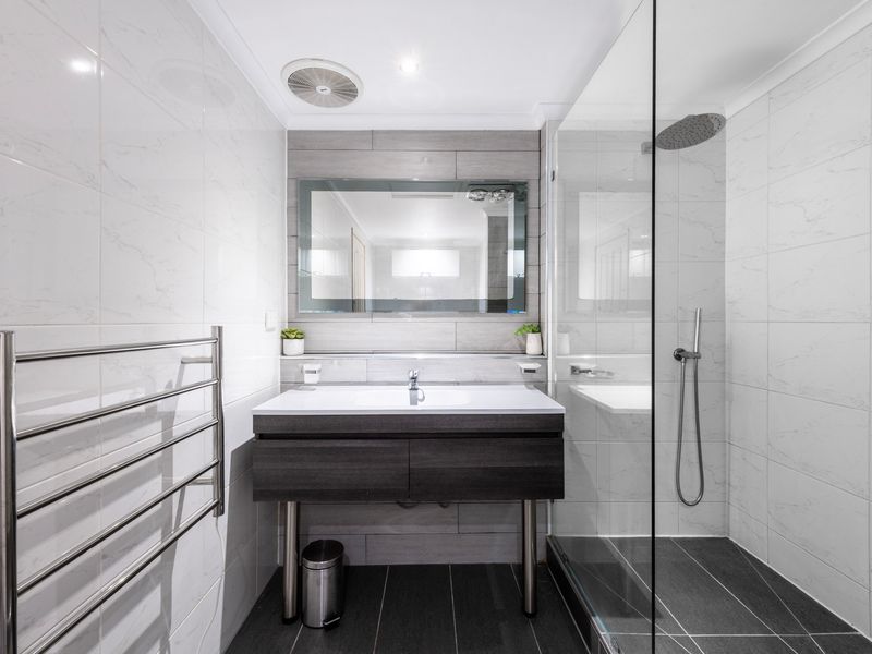 Modern bathroom with clean lines and a spacious walk-in shower, offering a touch of luxury.