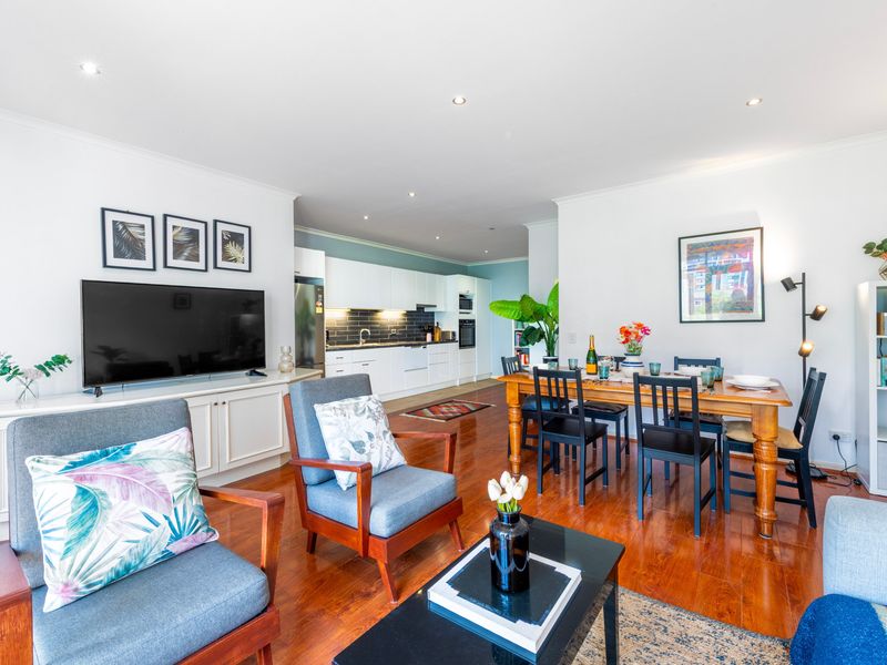 Open-plan living space with modern furniture, perfect for both relaxation and entertaining.