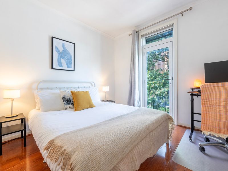 Unwind in this tranquil bedroom with soft tones and a view to match.