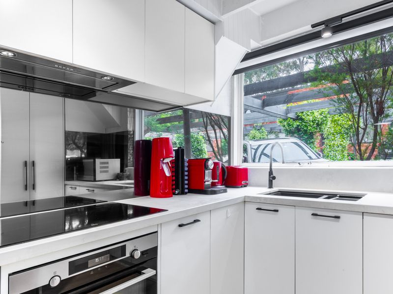 Fully equipped kitchen with quality appliances and garden views.