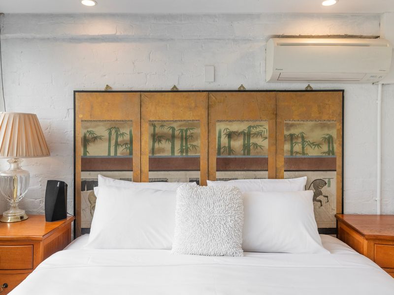 Charming bedroom with warm tones and timber furniture.