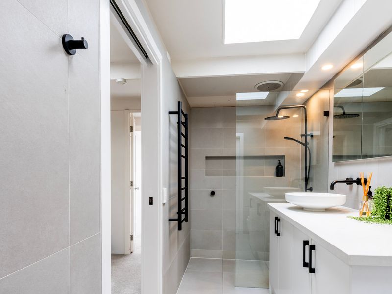 Sleek modern bathroom with walk-in shower.