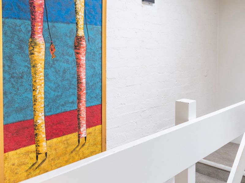 Colourful artwork adding a vibrant touch to the entryway.