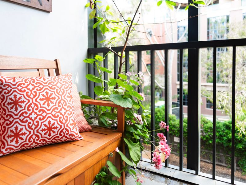 A quiet corner with a comfortable bench and decorative pillows — ideal for a morning coffee.