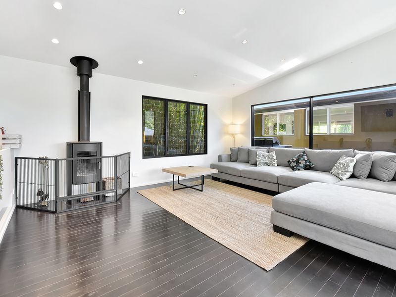 Light-filled living room where everyone can gather — unwind on the sofa, play games, or plan your next beach adventure.