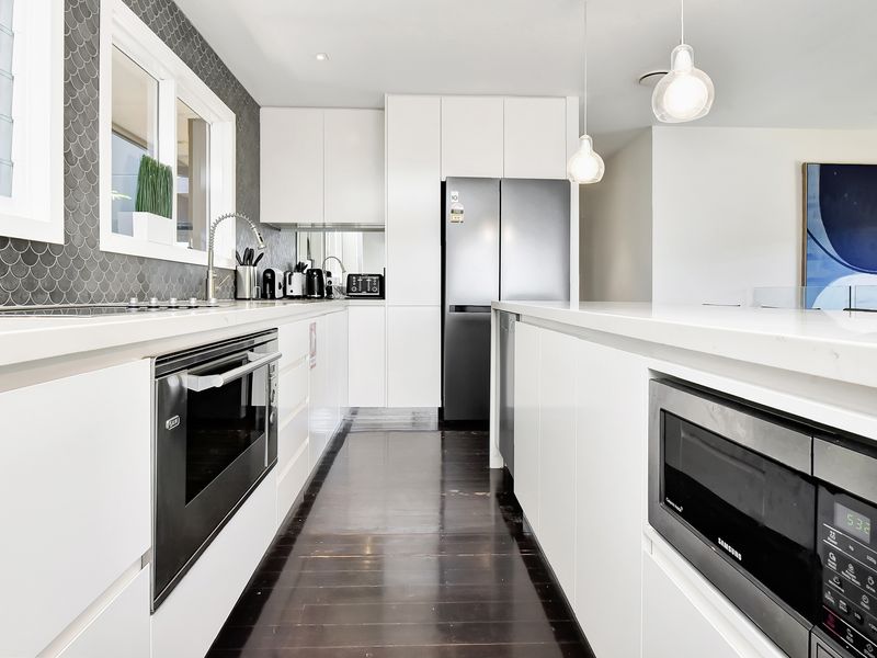 Modern kitchen: built-in oven and generous bench space.