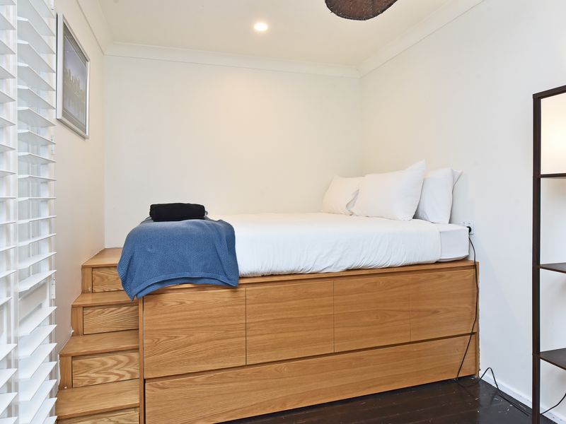 Airy guest room with plantation shutters