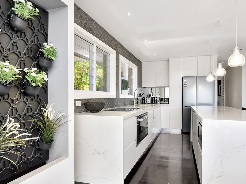 Vertical planted feature wall beside the kitchen for a fresh vibe.