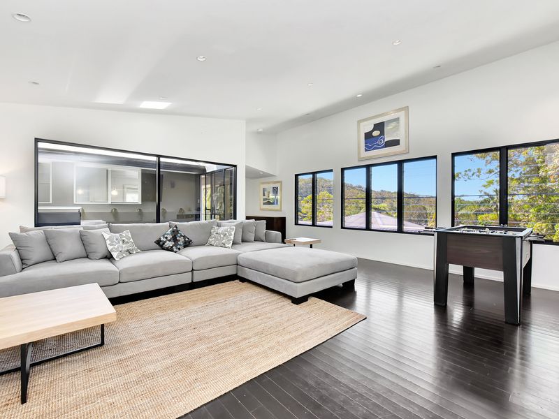 Bright living room with sectional sofa and timber floors.
