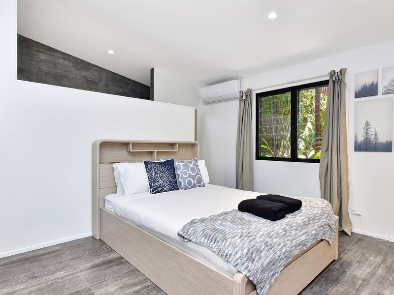 Bright and cosy bedroom with large windows and natural light
