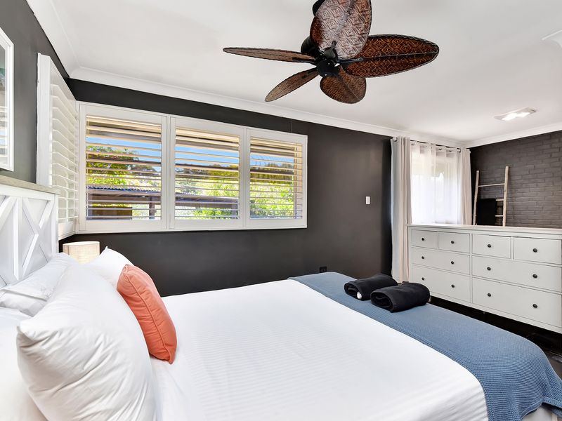 Inviting bedroom with ceiling fan and calming décor