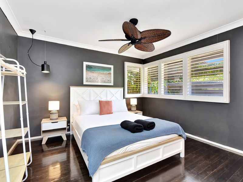 Fresh and tidy bedroom with storage and soft bedding