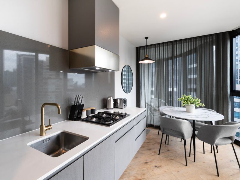 Stylish kitchen with premium appliances and sleek stone benchtops.