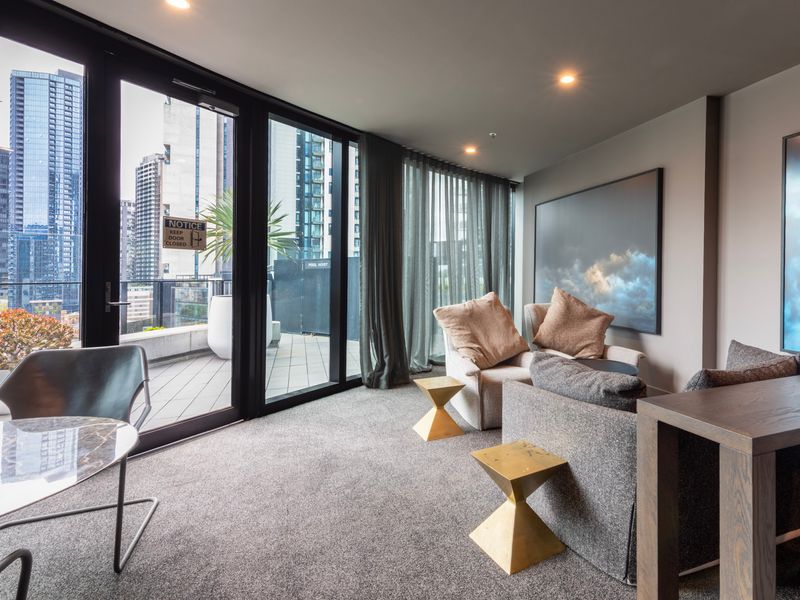 Inviting living room opening onto the balcony with floor-to-ceiling glass.