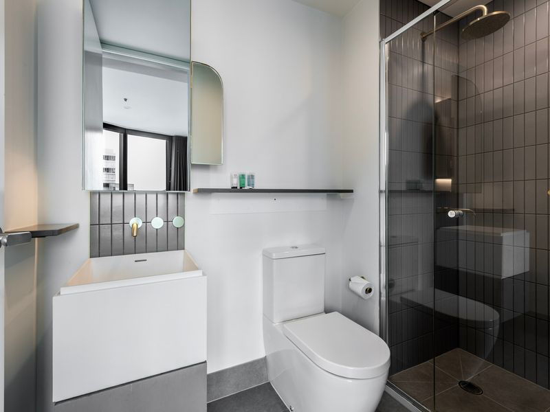 Modern bathroom with glass shower and clean minimalist design.