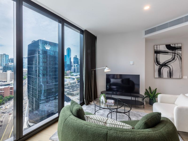 Cozy lounge area with large windows overlooking the Melbourne CBD.