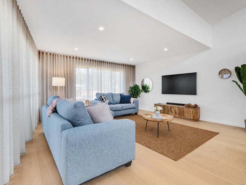 Sunlit lounge corner with plush seating and sheer curtains