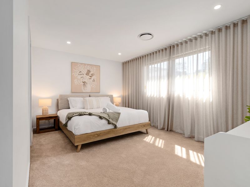 Peaceful bedroom with soft drapes and warm ambience