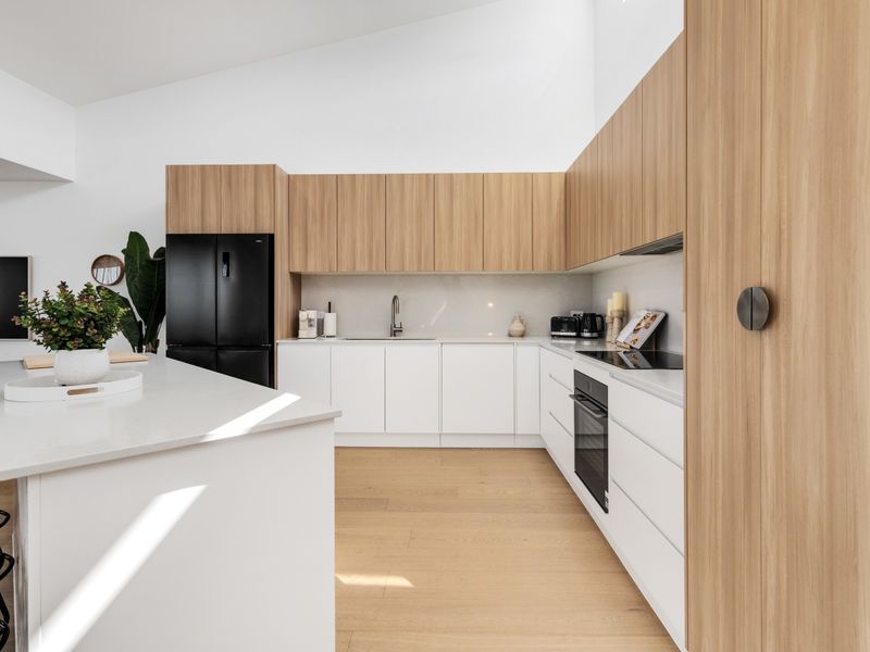 Stylish open kitchen with warm timber cabinetry