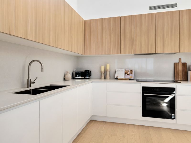 Modern kitchen prep zone with double sink and built-in oven