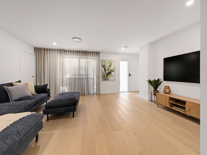 Spacious lounge with comfy seating and TV