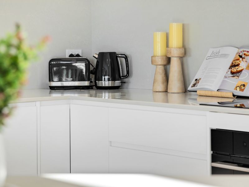 Coffee station with kettle, toaster, and essentials