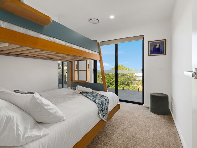 Modern bedroom with bunk beds and balcony access