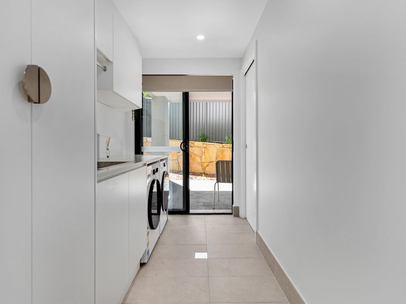 Sleek compact laundry nook with outdoor access
