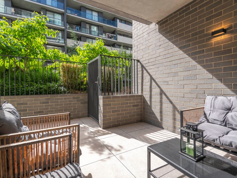 Sunlit courtyard corner with comfortable outdoor seating.