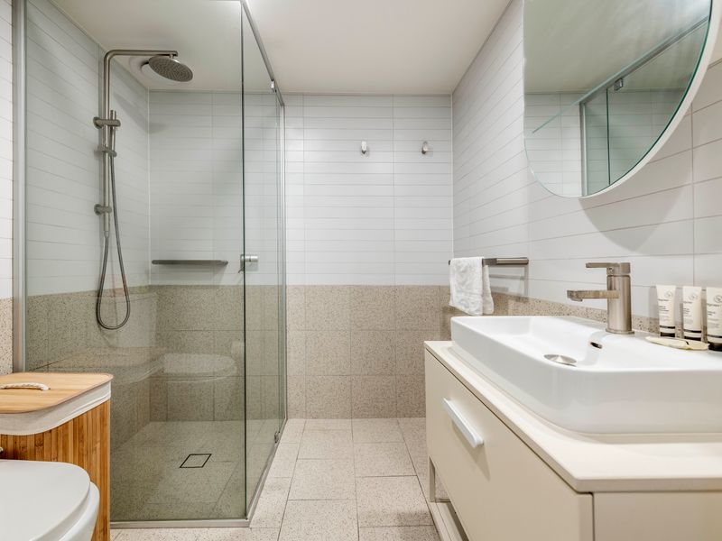 Modern walk-in shower with sleek tiling and great water pressure.